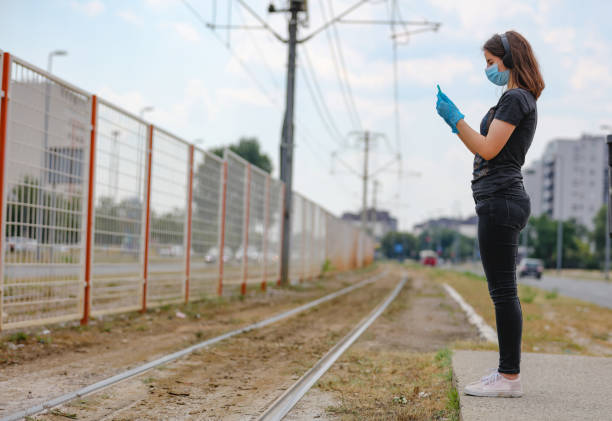 istock Teenager checking on app when the next tramway is due amid covid-19 oubreak 1267280141