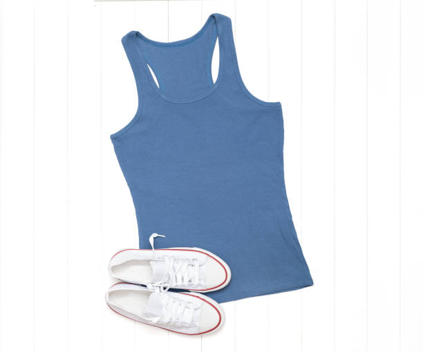 istock Blue tank top and white sneakers on a light background 1267282487