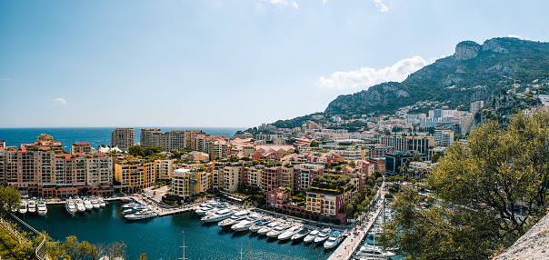 Panorama at day time, capturing the harbour and the mountain on the other site of Monte Carlo