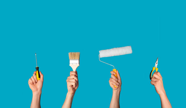 istock House redecoration concept. Collage with male hands holding different tools over blue background, free space 1267283034