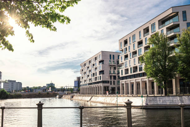 modern cubic residential architecture in berlin at river side in late afternoon sun