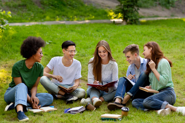 istock Learning Concept. Group of college friends preparing for lessons outdoors, studying together 1267283956
