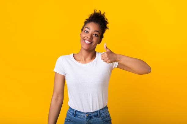 istock Afro woman showing thumb up and smiling 1267283998