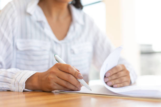 istock Business woman reading paper document in modern office 1267285529