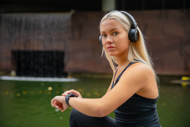 istock Fit female runner using smart watch to monitor her performance 1267285718