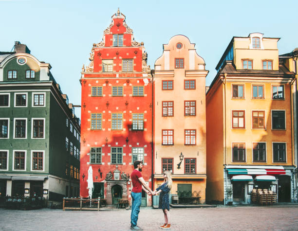 Couple in love holding hands together in Stockholm romantic date walk summer vacations lifestyle Stortorget architecture colorful houses Sweden landmarks Couple in love holding hands together in Stockholm romantic date walk summer vacations lifestyle Stortorget architecture colorful houses Sweden landmarks stortorget stock pictures, royalty-free photos & images
