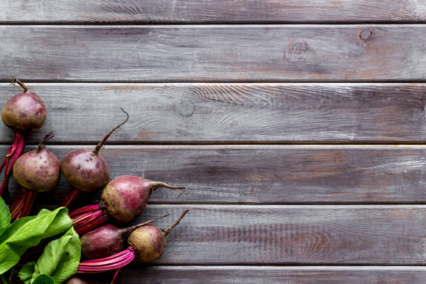 istock Beet - fresh, with leaves - on wooden table top view copy space 1267285838