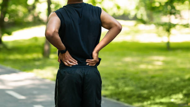 istock Black guy having back pain during his morning run at park, copy space 1267287092