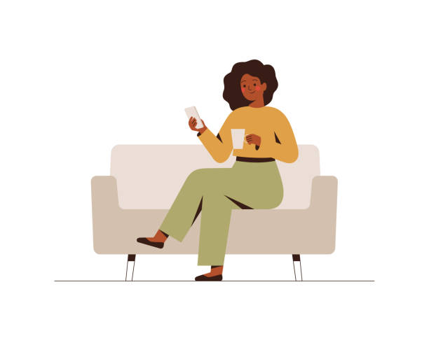 The black businesswoman is sitting on the couch with a mobile phone at the break time. The black businesswoman is sitting on the couch with a mobile phone at the break time. Young dark skin girl drinking coffee and using a smartphone. Flat cartoon vector illustration. using phone illustrations stock illustrations
