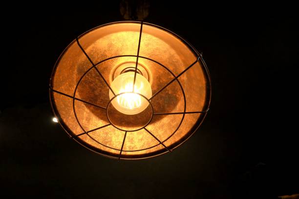 istock A modern lamp light shines in the dark room background 1267288242