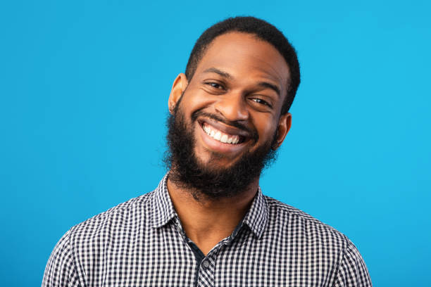 istock Smiling afro man portrait on blue background 1267289182