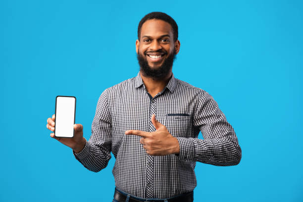 istock Afro guy showing blank white mobile phone screen 1267289237