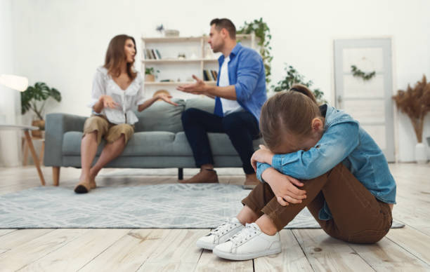 istock Daughter Crying While Parents Having Quarrel Sitting At Home 1267289448