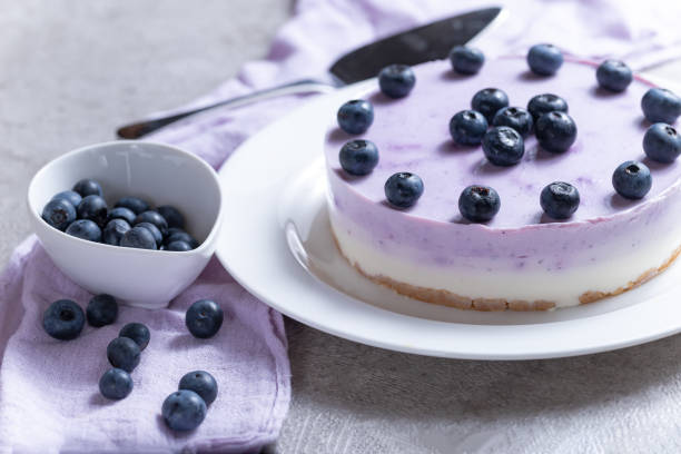 istock Vanilla blueberry cheesecake decorated with fresh berries on a gray table 1267290762