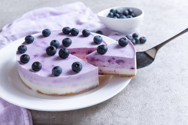 istock Vanilla blueberry cheesecake decorated with fresh berries on a gray table 1267290806
