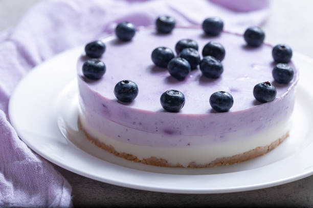 istock Vanilla blueberry cheesecake decorated with fresh berries on a gray table 1267290871