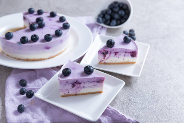 istock Vanilla blueberry cheesecake decorated with fresh berries on a gray table 1267290897