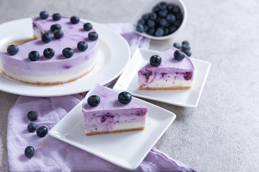 Vanilla blueberry cheesecake against gray background.Sweet healthy food. Copy space.