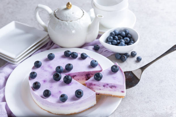istock Vanilla blueberry cheesecake decorated with fresh berries on a gray table 1267290915