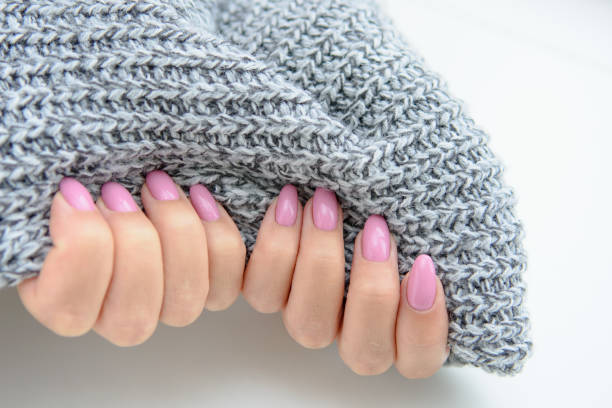 istock Women's hands with a knitted product, isolated on a white background. 1267291487