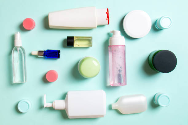 istock Close-up set of diffrent sized bottles and jars for cosmetic products on colored backgound. Face and body care concept with copy space 1267292035