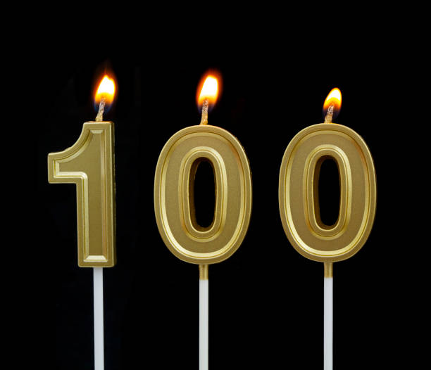 istock Birthday golden candle on black background, number 100 1267292582
