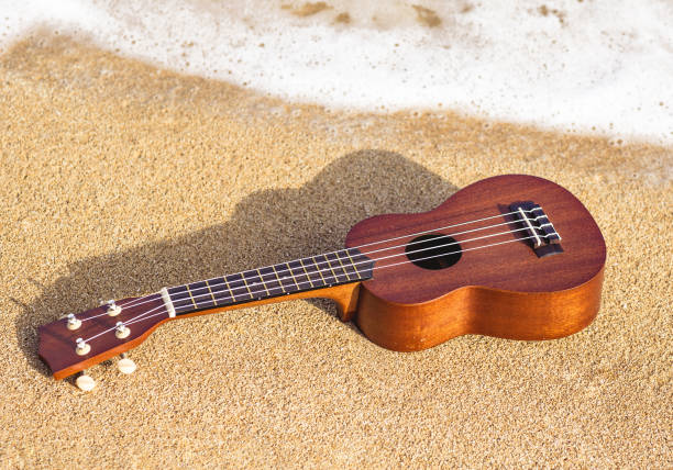 istock Ukulele guitar lying on the beach in Hawaii. 1267292708