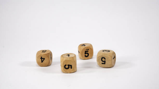 istock Four wooden dice on white background 1267293432