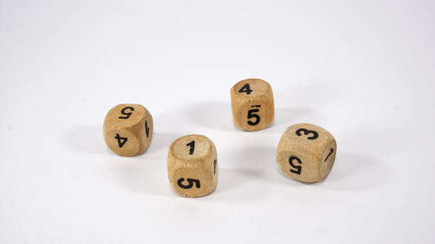 istock Four wooden dice on white background 1267293467
