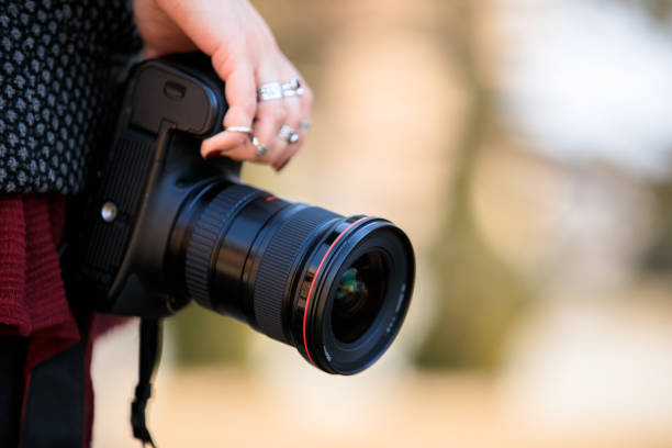 istock woman hand camera in street 1267295674