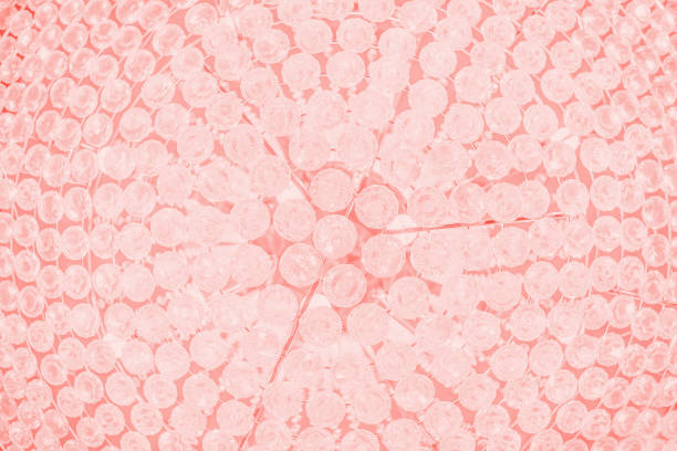 Crystal lamp, details. Fragment. Crystal part from chandelier, glamour light background. Pink toned