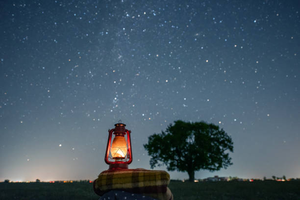 old red petrol lamp on a cozy blanket old red petrol lamp on a cozy blanket. a sky full of stars. bokeh milky way. long exposure photography. clear night. light trails. cozy autumn and winter background. glamping photos stock pictures, royalty-free photos & images