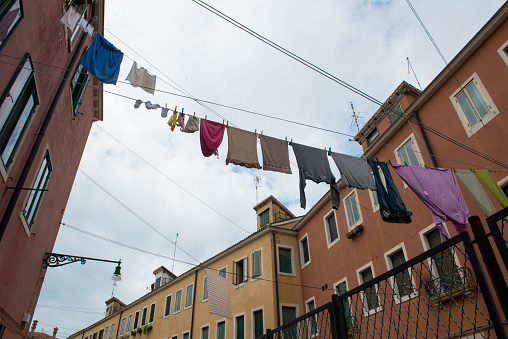 Venice street with clothes hanging out to dry between old houses. The Italian way of life.