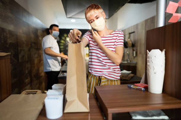istock Preparing and delivering safely - fast food restaurant in coronavirus times 1267298988