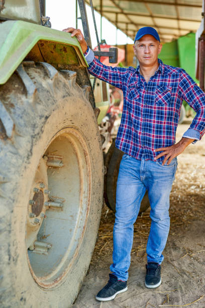 istock farmer driving tractor in countryside 1267299913