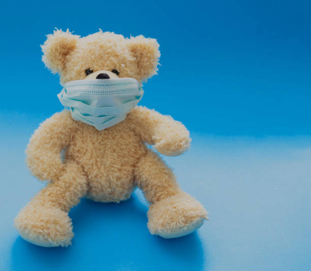 istock Coronavirus and pollution protection concept. Teddy bear with protective face mask on blue background 1267300099
