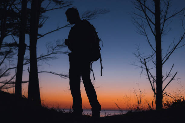 istock Beach camp after sunset. Silhouettes on a gradient sky. Nature retreat 1267300298
