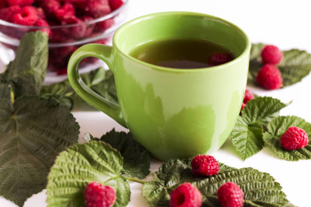 istock Raspberry herbal tea with fresh berries and leaves on white 1267302703