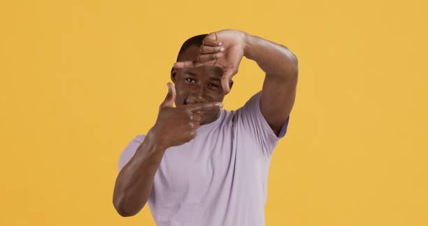 istock African american man looking through fingers border to camera 1267302766
