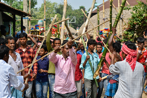 Barddhaman, West Bengal, India - April 12, 2019; A folk festival is held in April in West Bengal, India, where local people fight artificially with bamboo. In the local language, it is called Charak Utsav.