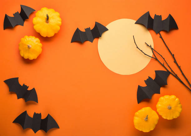 istock Halloween paper decorations on orange background 1267305021