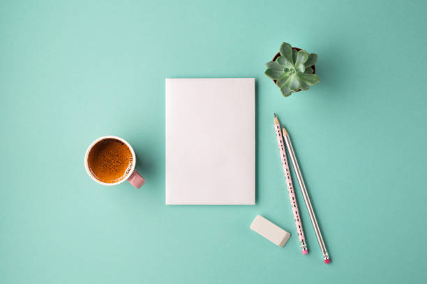 Flat lay stylish set with card, plant and coffee.