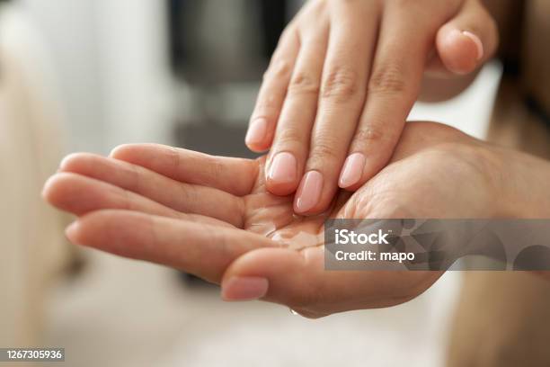 Japanese Esthetician Holding A Massage Oil In Her Hand Stock Photo - Download Image Now