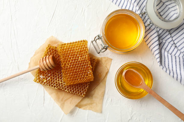 istock Composition with honeycombs and honey on white background 1267306530