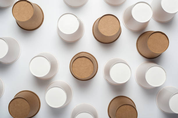 istock White and brown paper cups flipped upside down on a light background. Top view, flat lay 1267306535