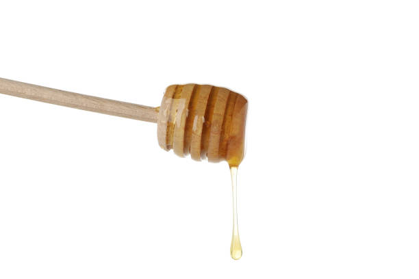 istock Wooden dipper with honey isolated on white background 1267306888