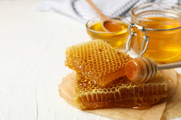 istock Composition with honeycombs and honey on white background 1267307636