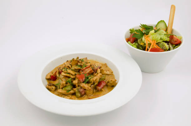istock curry sauce on the plate of chicken with vegetables on a white background 1267307946