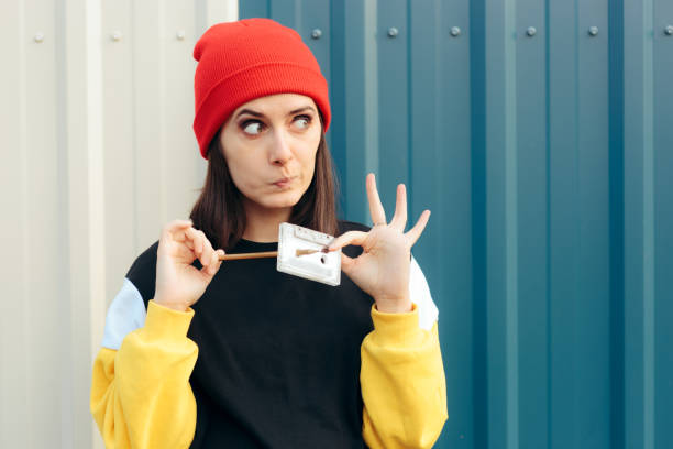 Millennial Hipster Girl Holding an Audio Tape Cassette and a Pencil Retro nostalgia concept portrait with woman and analogue technology lifehack stock pictures, royalty-free photos & images