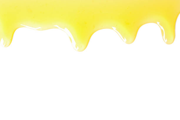 istock Tasty honey dripping isolated on white background 1267309110